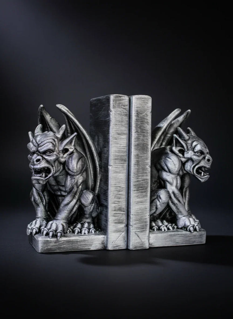 Gargoyle bookends on a black background