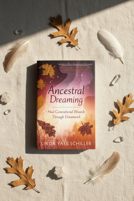 Book titled 'Ancestral Dreaming' by Linda Yael Schiller with autumn leaves and feathers on a textured surface.