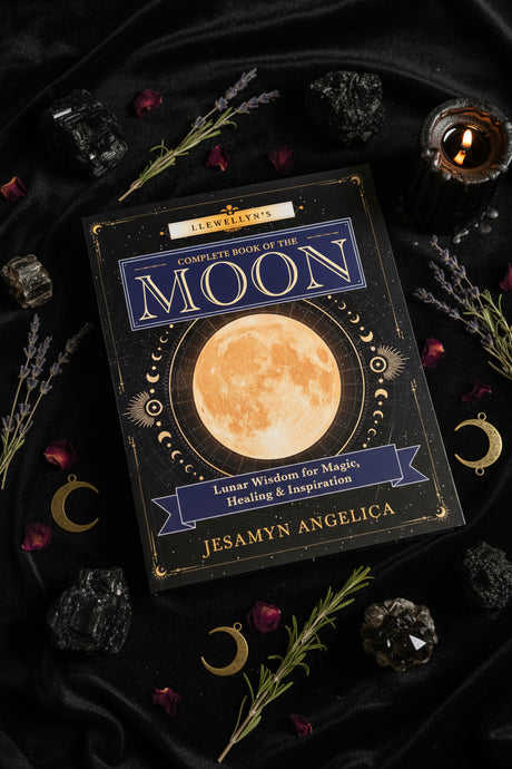 The front cover of the book 'Llewellyn's Complete Book of the Moon' by Jesamyn Angelica, featuring a large central moon illustration on a dark navy background with gold and blue text.