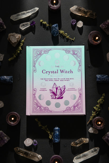 Book titled 'The Crystal Witch' with a purple crystal design on a dark background