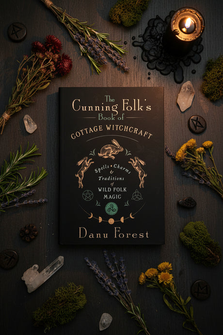 The Cunning Folk's Book of Cottage Witchcraft by Danu Forest, featuring a dark navy cover with gold and white text and illustrations of a rabbit and magical symbols.