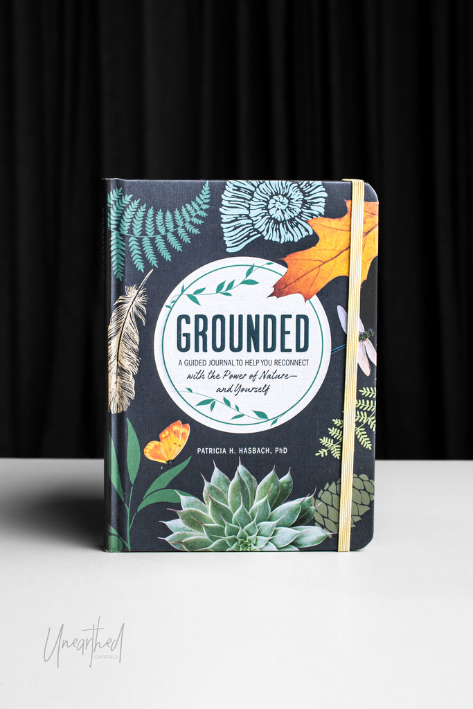 Notebook titled 'Grounded' with nature-themed design on a black background