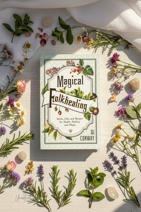 Book titled 'Magical Folkhealing' by DJ Conway surrounded by herbs and flowers on a light background