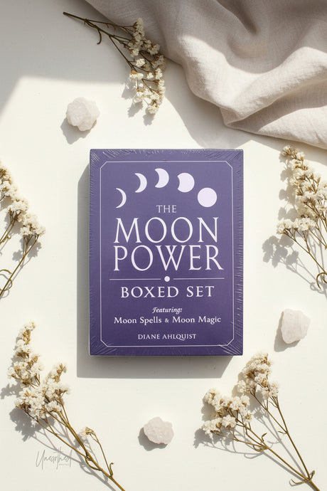 Moon Power boxed set on a light background with flowers and stones