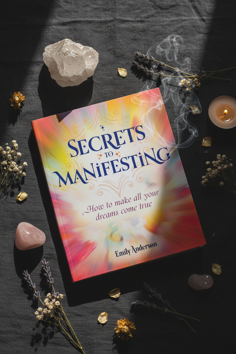 Book titled 'Secrets to Manifesting' by Emily Anderson on a dark surface with crystals and candles.