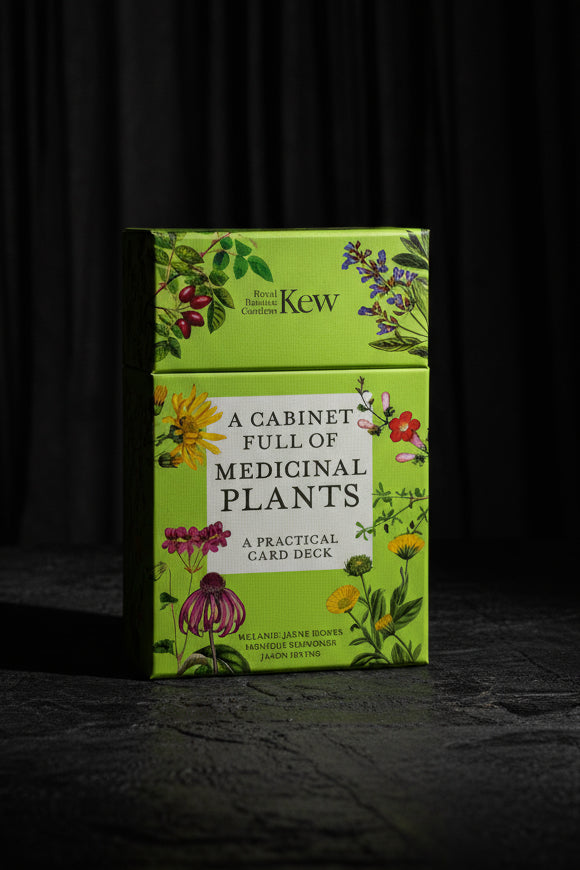 Card deck box titled 'A Cabinet Full of Medicinal Plants' by Kew on a gray surface with a black background.