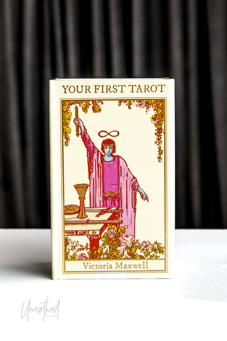 Tarot Deck titled 'Your First Tarot' by Victoria Maxwell on a white surface with a dark curtain background
