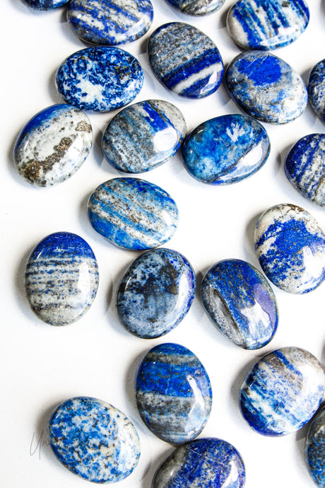 Collection of blue and white Lapis Lazuli stones on a white background