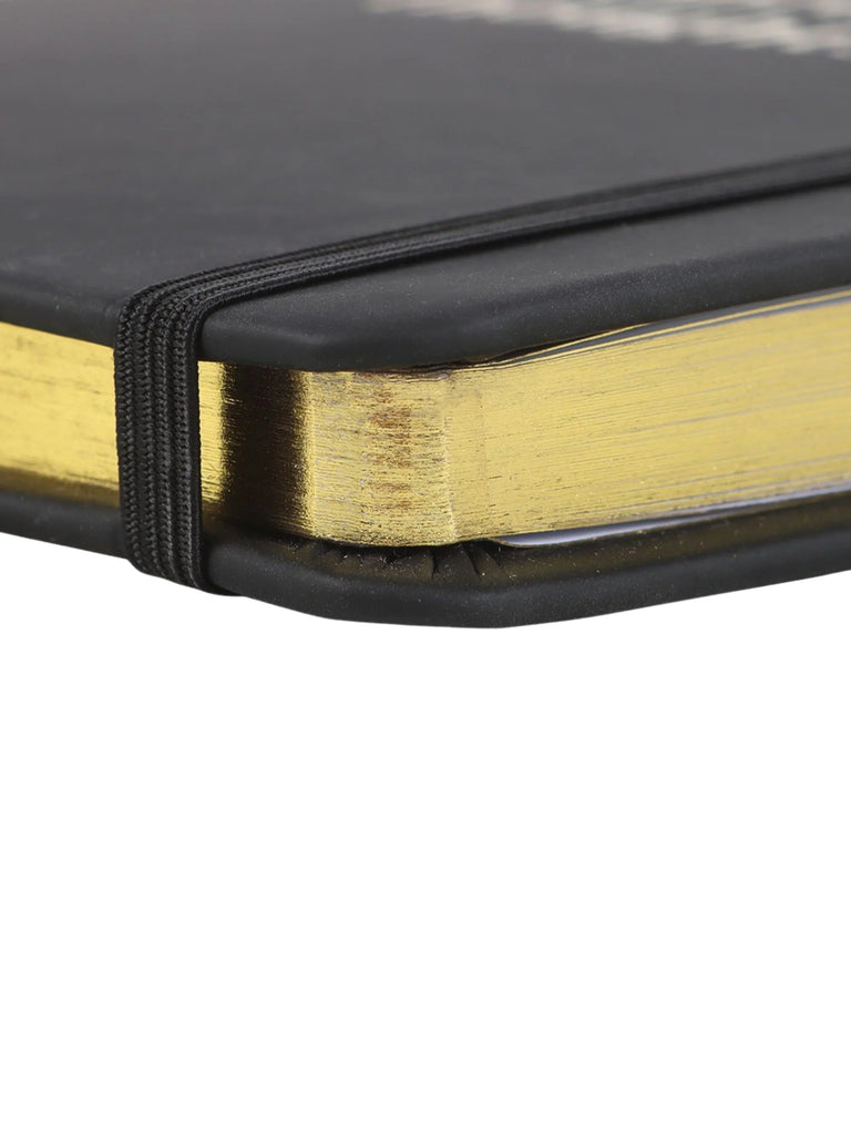 Close-up of a black and gold notebook on a white background