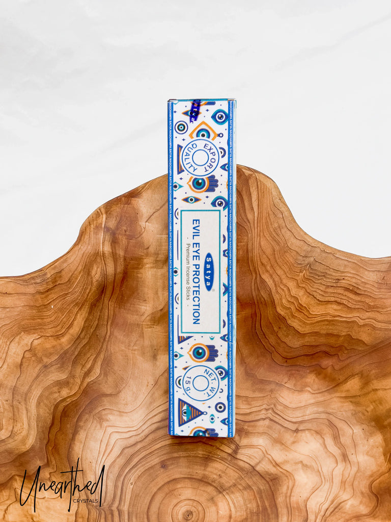 Incense box with blue and white design on a wooden surface
