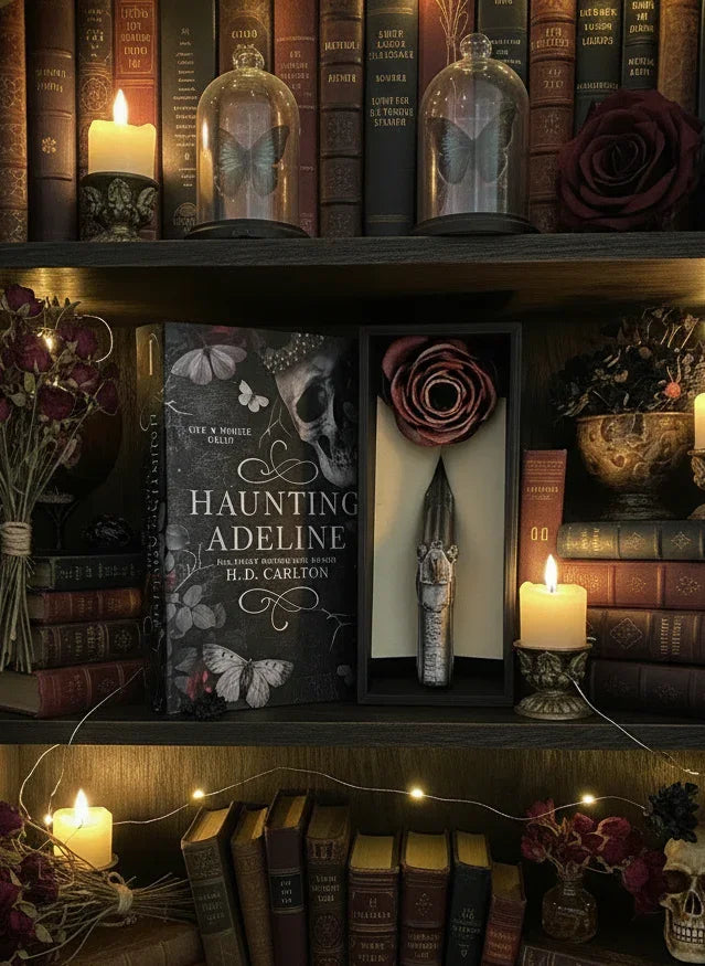 Bookshelf with 'The Haunting of Adeline' book, candles, and decorative items.