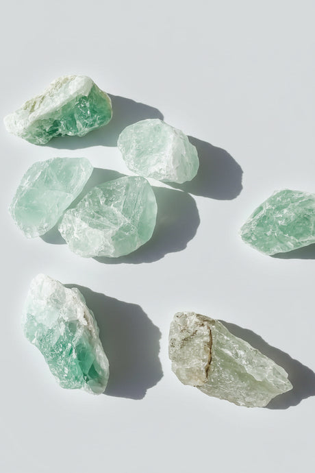 Green raw fluorite on a white background