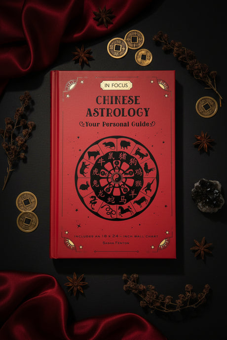 Red book titled 'Chinese Astrology' on a dark surface with decorative elements.