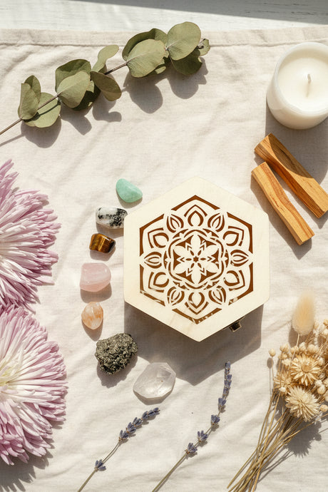 Decorative box with mandala design, crystals, and pink flowers on a white background